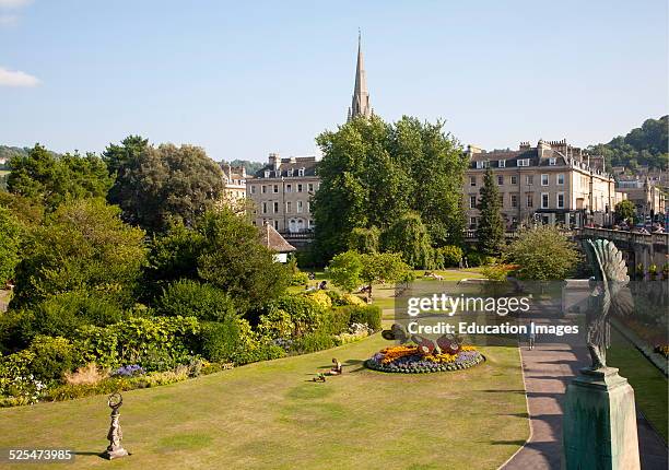 Parade Gardens public park in city center of Bath, Somerset, England with church spire in background.
