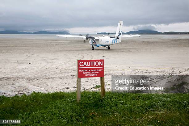 Flybe plane on sandy airstrip Isle of Barra airport, Outer Hebrides, Scotland.