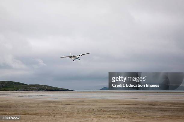 Flybe plane taking off from sandy airstrip Isle of Barra airport, Outer Hebrides, Scotland.