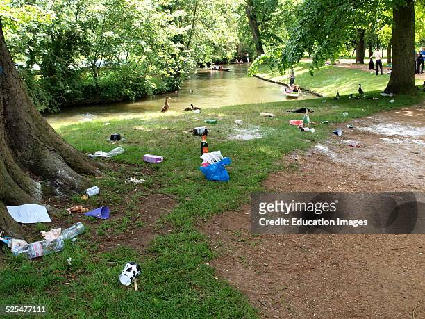 Rubbish left by Oxford students on the riverbank after a party, UK.