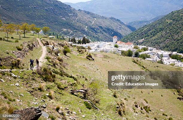 Walkers near the village of Capileira, High Alpujarras, Sierra Nevada, Granada province, Spain.