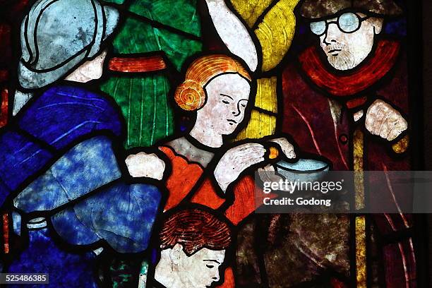 Alm giving stained glass.