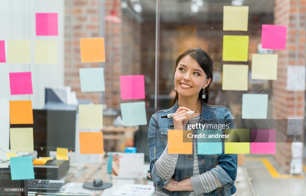 Woman thinking of ideas at the office