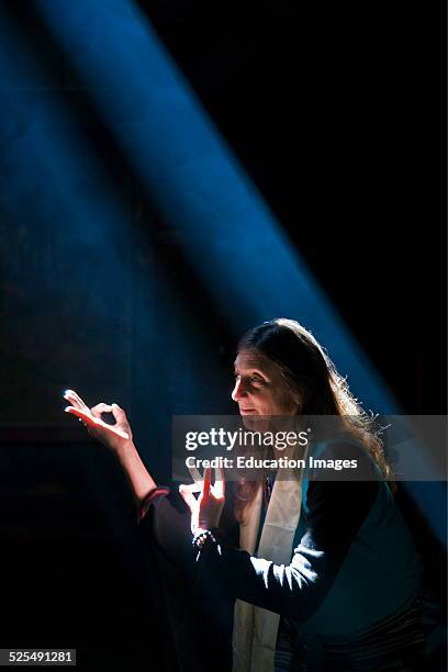 Woman Makes Buddhist Mudras In A Shaft Of Light, Nepal.