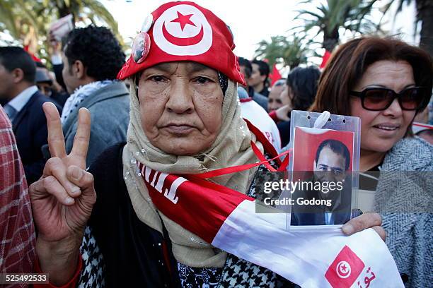 Tunisian woman holding a picture of murdered trade-unionist Chokri Belaid at the opening march of the World Social Forum in Tunis.