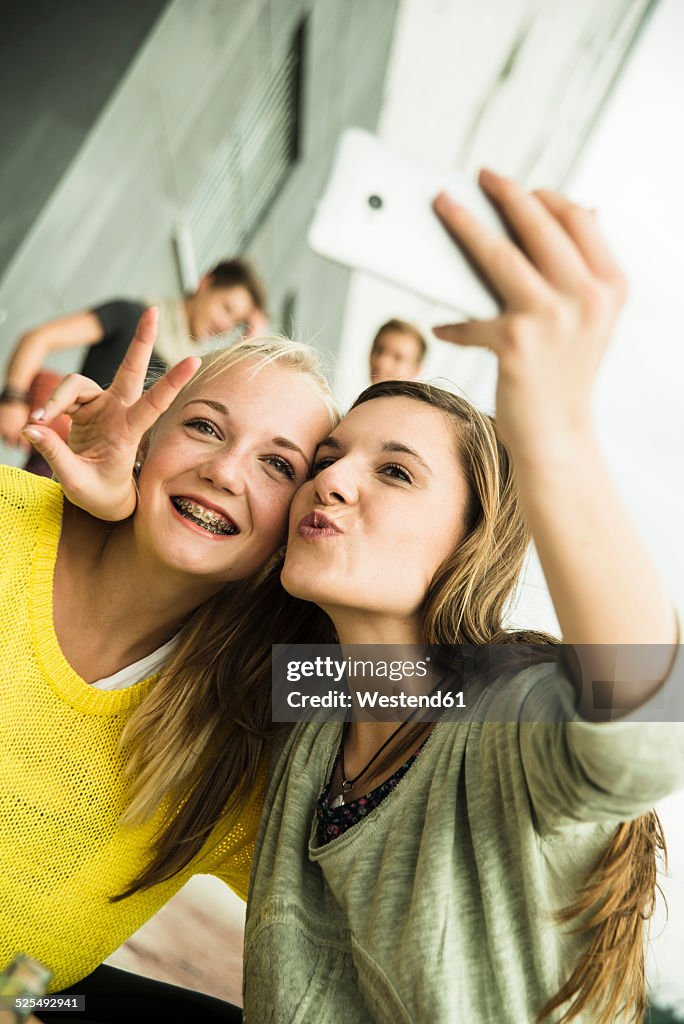 Two happy teenage girls taking a selfie