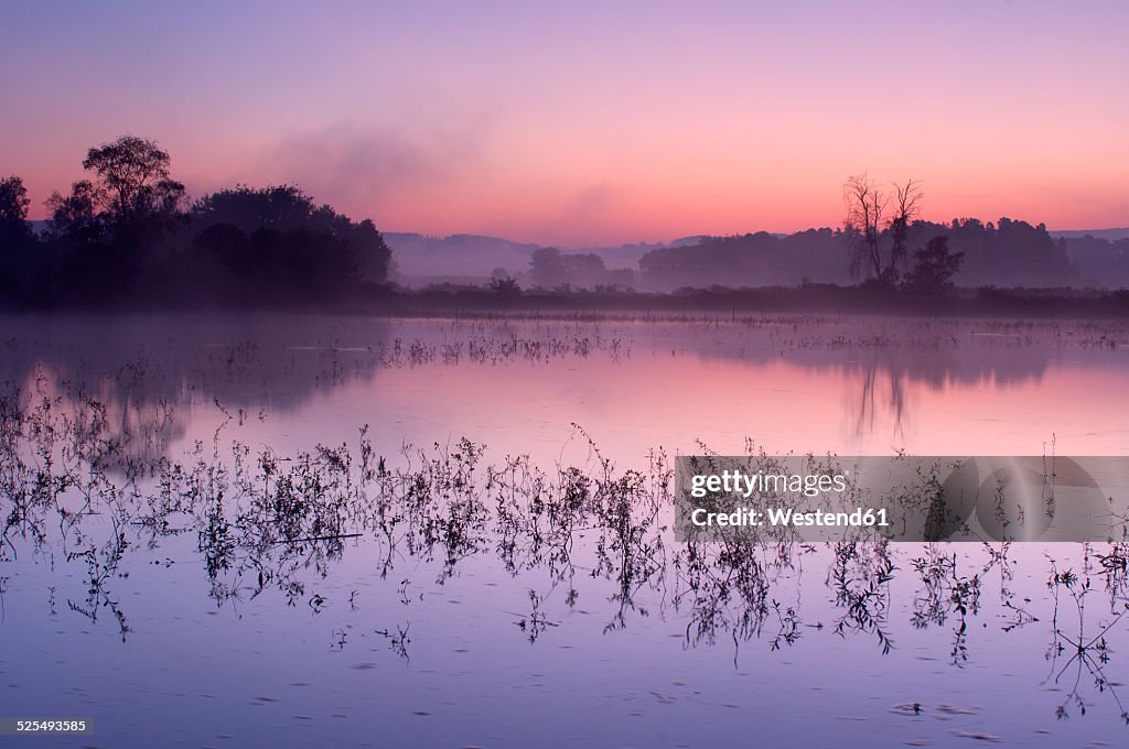 Germany, small lake at sunrise