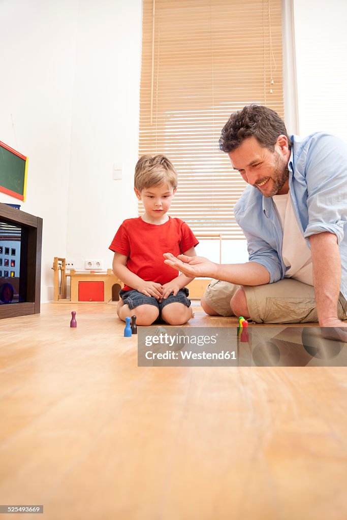 Father and son playing together in the nursery