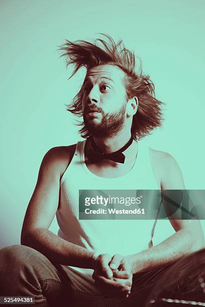 portrait of astonished young man with blowing hair - tousled hair man stock pictures, royalty-free photos & images