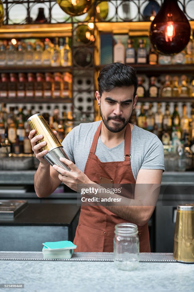 Barman making cocktails at a bar