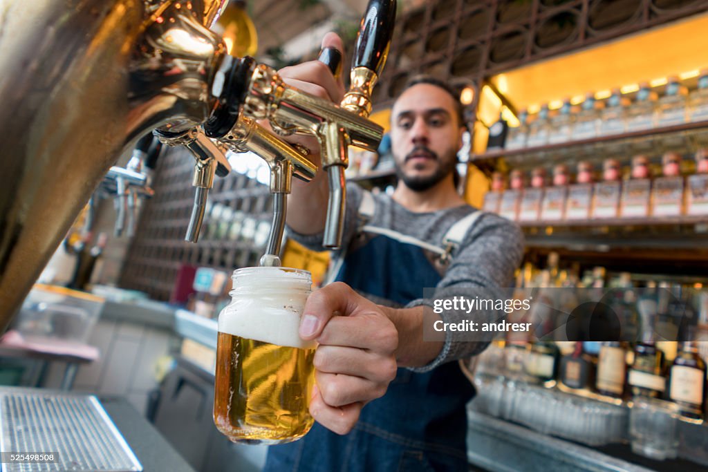 Man serving beer at a pub