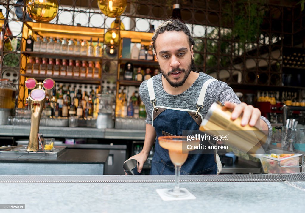 Bartender making cocktails at a bar