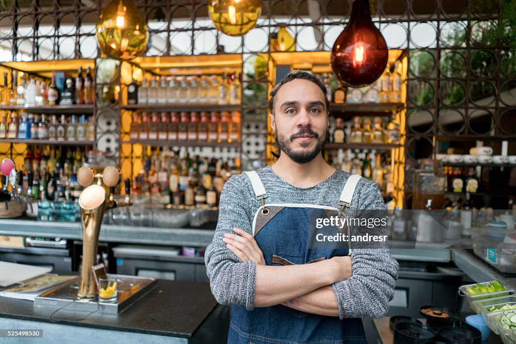 Business owner at a restaurant looking happy