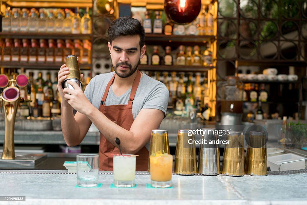 Bartender making cocktails at a bar