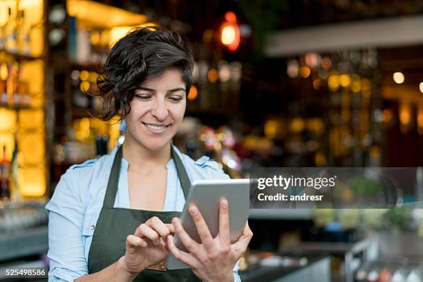 waitress using a tablet computer - waitress stock pictures, royalty-free photos & images