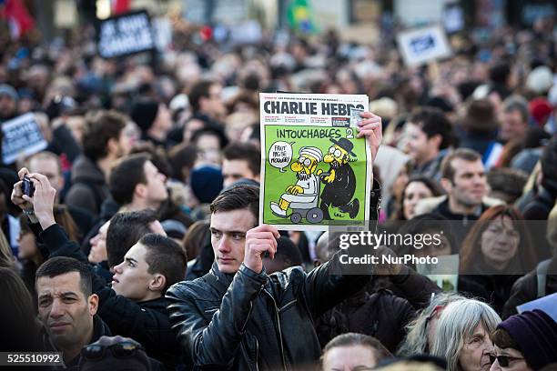 People holding cardboards reading &quot;Je suis Charlie take part in a Unity rally "Marche Republicaine" on the Place de la Republique in Paris on on...