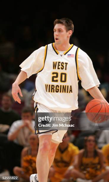 Mike Gansey of the West Virginia University Mountaineers drives against the Providence College Friars during the Big East Men's Basketball...