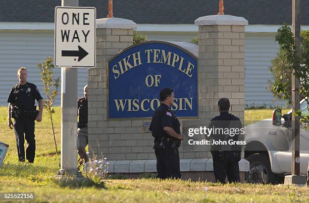 Police stand outside the Sikh Temple of Wisconsin in Oak Creek, Wisconsin, August 6, 2012. A gunman killed six people and critically wounded three at...