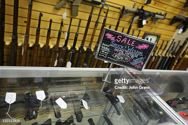 Sign advertising a "Home Defense Special" at the Shooters Shop in West Allis, Wisconsin, on August 7 the same store where alleged gunman Wade Michael...