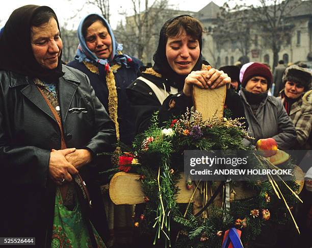 Mourners grieving for family members killed in the violent revolution of 1989 that led to the overthrow and execution of Communist leader Nicolae...