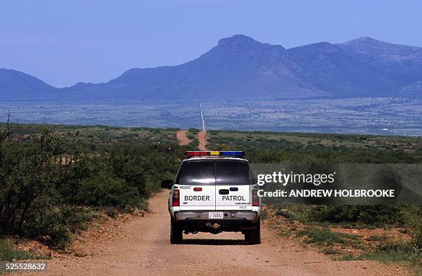 Border Patrol driving along the U.S.-Mexican border, looking for illegal aliens who may have crossed into the United States.