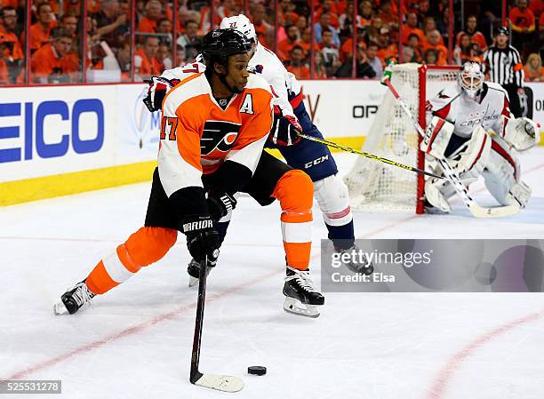 Wayne Simmonds of the Philadelphia Flyers wraps around the net as Karl Alzner of the Washington Capitals defends in Game Three of the Eastern...