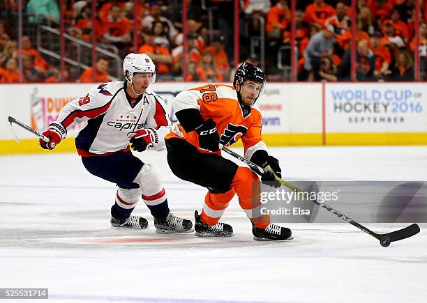Chris VandeVelde of the Philadelphia Flyers takes the puck as Nicklas Backstrom of the Washington Capitals defends in Game Three of the Eastern...