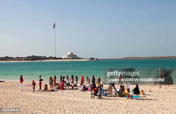 January 19, 2012 - Woman and children enjoying Abu Dhabi's on the beach side of the Corniche. Abu Dhabi's coast is on the Arabian Sea. The Abu Dhabi...