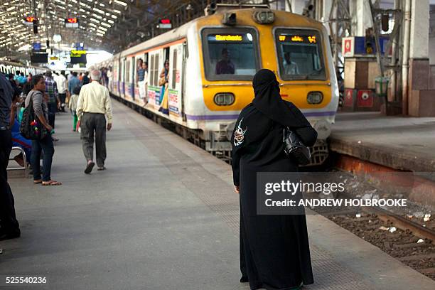 January 29, 2012 - Muslim woman waits on the platform for her passenger train to arrive in Churchgate Railway Station in South Mumbai.