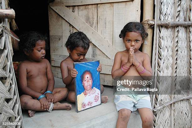 Manni Kannan sits in the doorway with a photo of his deceased mother alongside his two sisters, Janaki and Geetha . Dubbed the "tsunami baby" of...