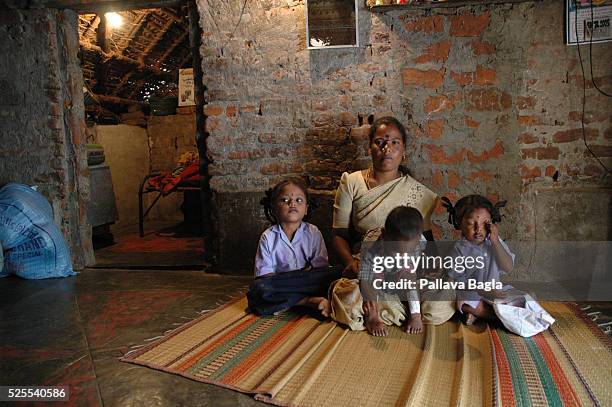 Manni Kannan in the arms of his mother Mrs. Dhaumani in their basic, rented accomodation with his sisters Geetha and Janaki . Nine months after the...