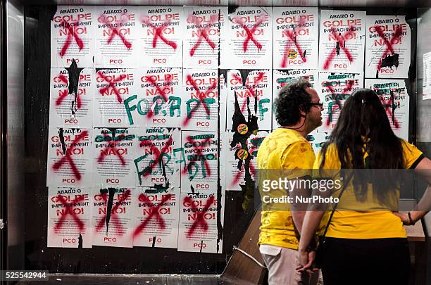 Protesters read signs against Dilma Rousseff's impeachment, covered with graffiti, during this sunday's demonstration in avenida Paulista, downtown...
