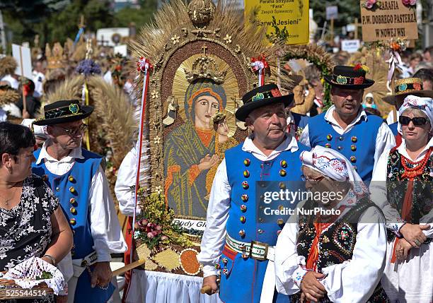 Hundreds of people dressed in traditional folk costumes with wreaths from their Parishes during the wreaths presentation at the 2015 edition of the...