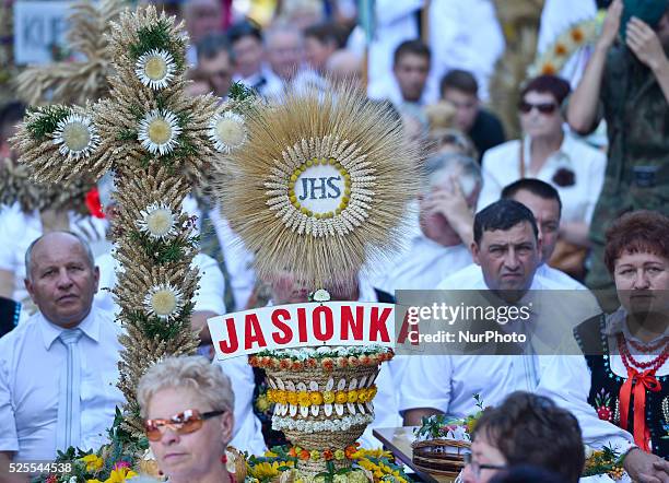 Representatives from Jasionka Parish, seat near one of their Parishes wreaths and loaves during the Holy Mass at the 2015 edition of the annual...