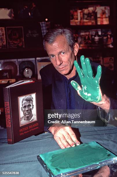 Peter Beard signs his book '50 Years of Portraits' at Rizzoli in SoHo with his hand dipped in green ink, New York, New York, November 30, 1999.