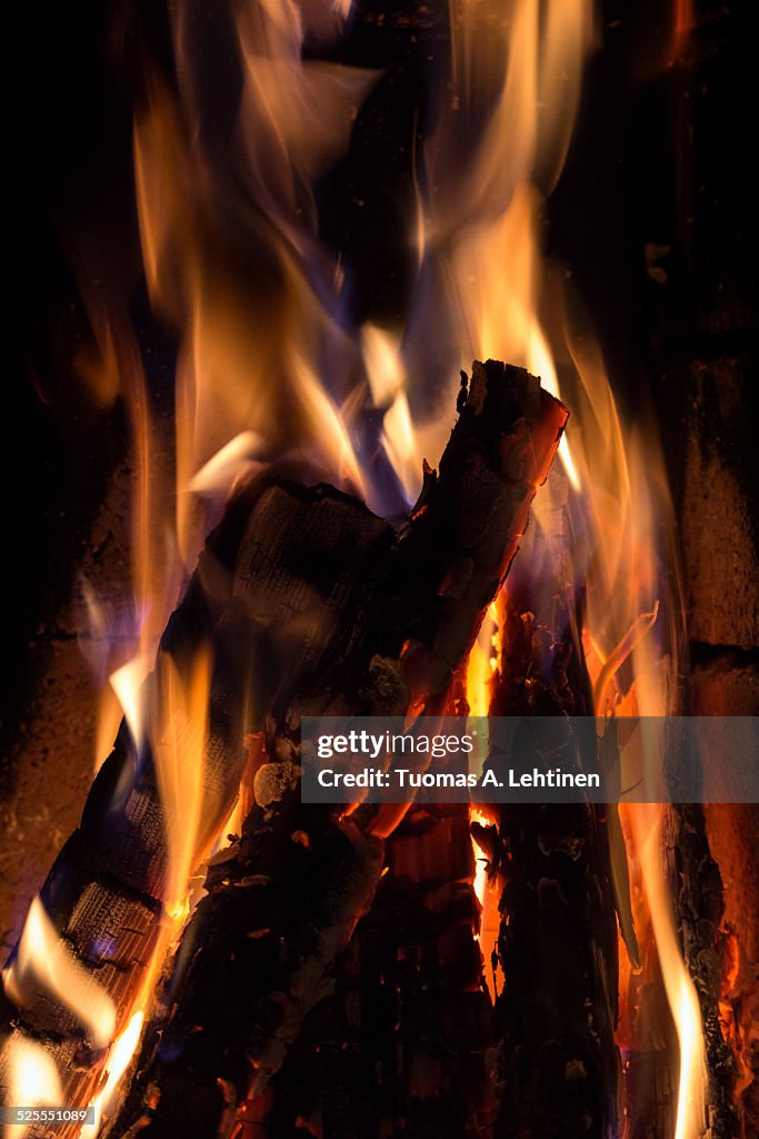 Closeup of burning & flaming firewood in fireplace