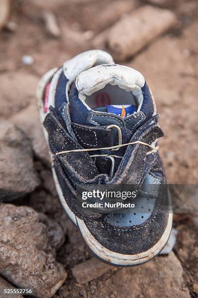 Infant leather and suede sneakers found tied together with elastic bands near Eftalou on the island of Lesbos. Shoes found on the beaches and around...