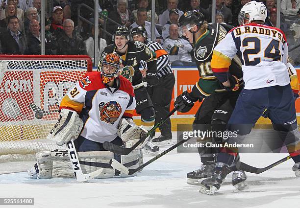 Devin Williams of the Erie Otters stops a scoring attempt by Christian Dvorak of the London Knights during game four of the OHL Western Conference...