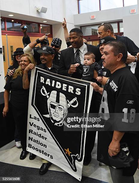 Former Oakland Raiders player Napoleon McCallum poses with Raiders fans as he arrives at a Southern Nevada Tourism Infrastructure Committee meeting...