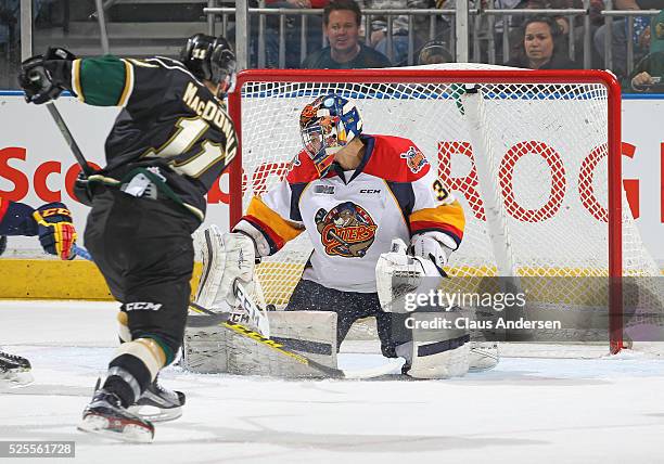 Owen MacDonald of the London Knights fires a puck past Devin Williams of the Erie Otters during game four of the OHL Western Conference Final on...