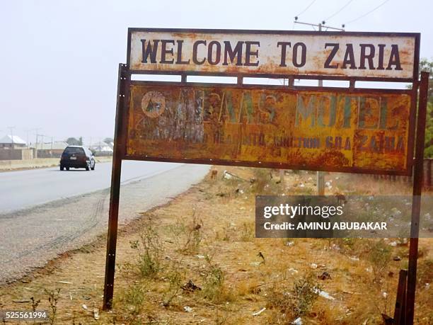 Picture taken on April 26, 2016 shows a vehicle driving past sign post outside the northern Nigerian city of Zaria, where around 350 members of the...