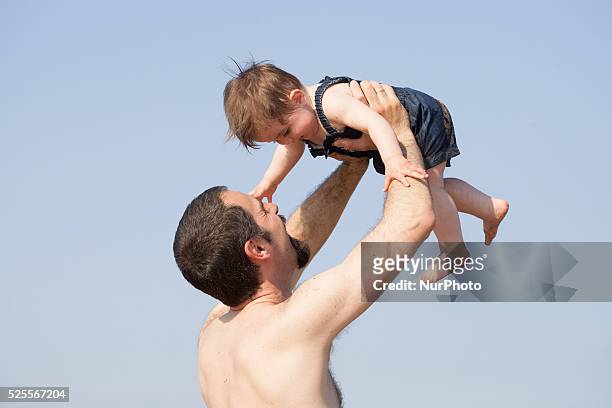 Father and son are seen playing on the beach during a hot weather spell on 1st July 2015 in The Hauge, Netherlands.