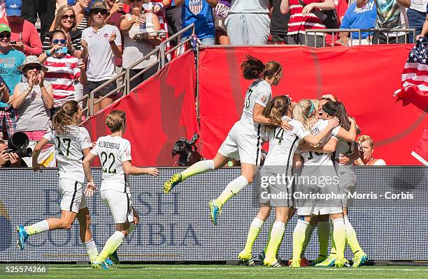Carli Lloyd and team USA celebrate Lloyd's second goal during 2015 women's World Cup Soccer in Vancouver during the final between USA and Japan.