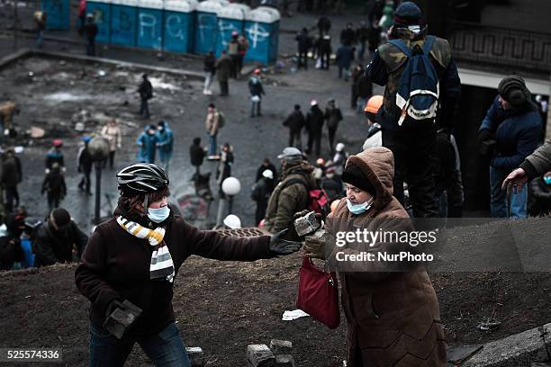 Protesters try to rebuild the barricades after police retreat