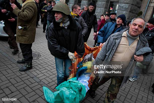 People carry the victim of the sniper fire