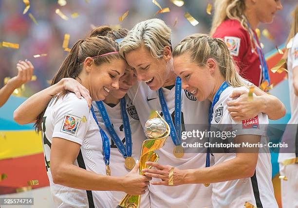 Alex Morgan , Lauren Holiday, Abby Wambach, and Whitney Engen of team USA celebrate with the World Cup trophy after their victory during 2015 women's...