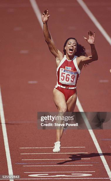 Florence Griffith-Joyner of the United States celebrates winning gold in the Women's 100 metres final on 24th September 1988 during the XXIV Olympic...