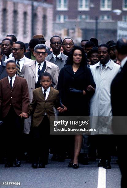 Coretta Scott King, along with her sons and Reverend Abernathy, walk through the streets of Memphis after the assassination of her husband, civil...