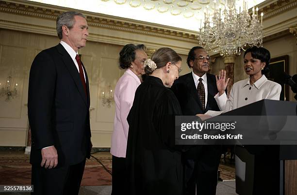 Secretary of State Condoleezza Rice raises her right hand and is sworn into office by Associate Supreme Court Justice Ruth Bader Ginsburg during a...