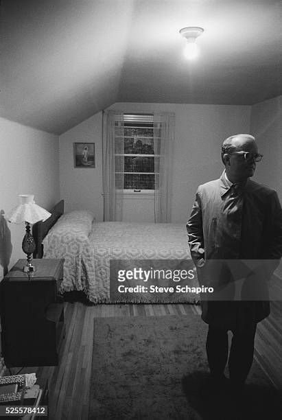 View of American author Truman Capote as he stands in a bedroom, during the filming of 'In Cold Blood' , Holcomb, Kansas, April 1967. The film was...